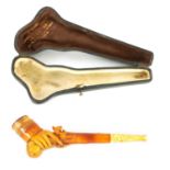 A 19TH CENTURY MEERSCHAUM PIPE DEPICITING A HAND HOLDING A PISTOL