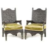A PAIR OF 19TH CENTURY INDIAN CARVED HARDWOOD ARMCHAIRS
