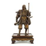 A FINE QUALITY JAPANESE MEIJI PERIOD PATINATED BRONZE AND GILT SCULPTURE OF A SAMURAI WARRIOR BY MIY