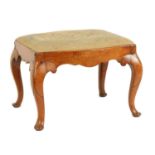 A GEORGE II SERPENTINE SHAPED WALNUT STOOL