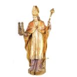 AN 18TH CENTURY CONTINENTAL CARVED POLYCHROME FIGURE OF ST. LUDGERUS