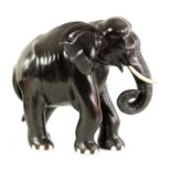 A LARGE LATE 19TH CENTURY ANGLO-INDIAN CARVED EBONY ELEPHANT
