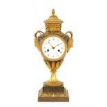 AN EARLY 19TH CENTURY BRONZE AND GILT BRONZE FRENCH URN SHAPED MANTEL CLOCK