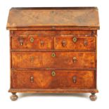 AN EARLY WILLIAM AND MARY FIGURED WALNUT BUREAU