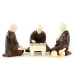 A JAPANESE MEIJI PERIOD BRONZE AND IVORY FIGURAL GROUP OF THREE ELDERS PLAYING GO & GO BANG GAME