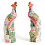 A PAIR OF COLOURFUL CHINESE FAMILLE ROSE ORNAMENTAL BIRDS PERCHED ON FLOWERING BRANCHWORK