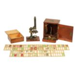 A LATE 19TH CENTURY BRASS MONOCULAR MICROSCOPE WITH A COLLECTION OF MICROSCOPE SLIDES