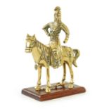 AN EARLY PERIOD CHINESE CAST BRASS MODEL OF A KNIGHT ON HORSEBACK