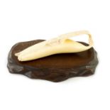 A LATE 19TH CENTURY JAPANESE MEIJI PERIOD CARVED IVORY SCULPTURE OF A HALF PEELED BANANA