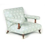 AN EARLY 19TH CENTURY UPHOLSTERED OPEN ARMCHAIR ATTRIBUTED TO HOWARD & SONS