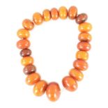 A STRING OF UNUSUALLY LARGE GRADUATED AMBER BEADS