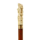 A 19TH CENTURY CARVED IVORY HANDLED WALKING STICK