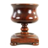 A 19TH CENTURY LIGNUM VITAE TREEN BOWL ON STAND