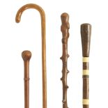 A COLLECTION OF FOUR WALKING STICKS INCLUDING A SWORD STICK