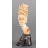AN ART NOUVEAU CARVED IVORY BUST OF A YOUNG LADY
