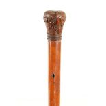 A LATE 18TH CENTURY CARVED HANDLED MALACCA WALKING STICK