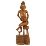 AN EARLY 20TH CENTURY BALINESE HARDWOOD CARVED NUDE LADY FIGURE