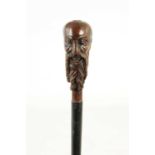 AN EARLY 20TH CENTURY TREEN CARVED HARDWOOD WALKING STICK