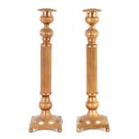 A PAIR OF PRESSED COPPER CANDLESTICKS