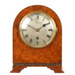 A SMALL EARLY 20TH CENTURY AMBOYNA CASED MANTLE CLOCK