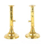 A PAIR OF GEORGIAN BRASS EJECTOR CANDLESTICKS