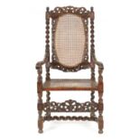 A CHARLES II CARVED WALNUT BERGERE ARMCHAIR