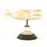 A 19TH CENTURY SCRIMSHAW-CARVED MARINE IVORY SCULPTURE MODELLED AS A SPERM WHALE