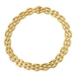 CARTIER. A LADIES 18CT YELLOW GOLD GENTIANE CHOKER NECKLACE