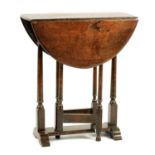 A 19TH CENTURY SLEDGE-FOOT OAK DROP LEAF TABLE OF 17TH CENTURY DESIGN