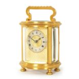 A LATE 19TH CENTURY GILT BRASS FRENCH MINIATURE CYLINDRICAL CARRIAGE CLOCK