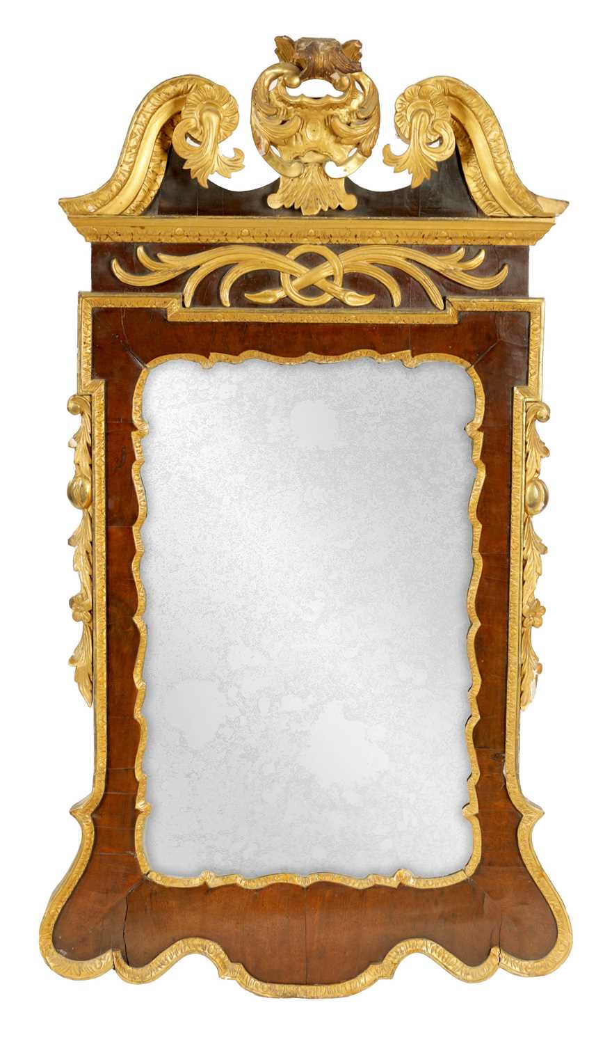 A GEORGE II WALNUT AND PARCEL GILT HANGING MIRROR OF GENEROUS SIZE