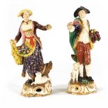 A PAIR OF 18TH CENTURY DERBY PORCELAIN FLOWER SELLER FIGURES