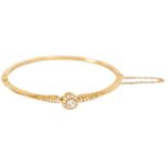 A LADIES 18CT GOLD AND DIAMOND BANGLE