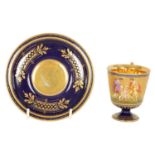 A FINE LATE 19TH CENTURY VIENNA STYLE RICHLY GILT AND ROYAL BLUE CABINET CUP AND SAUCER
