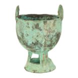 AN ANCIENT PATINATED BRONZE TWO HANDLED VESSEL - POSSIBLY ROMAN