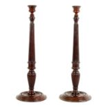 A PAIR OF 19TH CENTURY MAHOGANY WEIGHTED BASE CANDLESTICKS