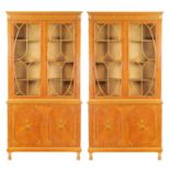 MAPLE & CO. A PAIR OF EDWARDIAN FIGURED SATINWOOD AND MARQUETRY INLAID GLAZED BOOKCASES