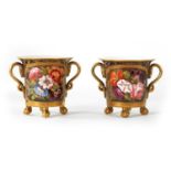 A PAIR OF EARLY 19TH CENTURY DUESBURY DERBY TWO-HANDLED CUPS RAISED ON CLAW AND BALL FEET