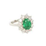 A LARGE 18CT WHITE GOLD EMERALD AND DIAMOND RING