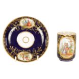 A LATE 19TH CENTURY VIENNA STYLE SCROLLED GILT AND ROYAL BLUE CABINET CUP AND SAUCER