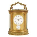 A LATE 19TH CENTURY OVAL ENGRAVED GILT BRASS CARRIAGE CLOCK REPEATER