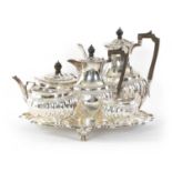 AN EDWARD VII FIVE PIECE SILVER TEA SERVICE TOGETHER WITH A SILVER PLATED SALVER