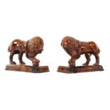 A GOOD PAIR OF 19TH CENTURY TREACLE GLAZED TERRACOTTA MEDICI LIONS