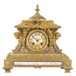 A 19TH CENTURY FRENCH PORCELAIN PANELLED ORNATE CAST BRASS MANTEL CLOCK