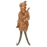 A LATE 19TH CENTURY BLACK FOREST CARVED LINDENWOOD COAT HOOK