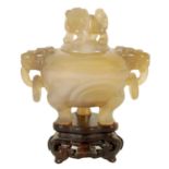 A CHINESE AGATE KORO AND COVER ON STAND