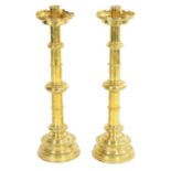 A PAIR OF LATE 19TH CENTURY BRASS OVERSIZED GOTHIC STYLE CANDLESTICKS