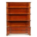 A REGENCY FIGURED MAHOGANY WATERFALL OPEN BOOKCASE