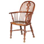 A 19TH CENTURY NOTTINGHAMSHIRE YEW WOOD LOW BACK WINDSOR ARMCHAIR