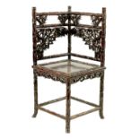 A 19TH CENTURY CHINESE CARVED ROSEWOOD CORNER CHAIR